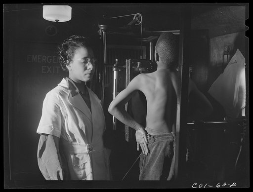 Untitled photo, possibly related to: Miss Marion Rhodes, a graduate nurse from Meharry Medical College, Nashville, Tennessee, assisting the x-raying of one of the children on the project. X-ray clinic at the hospital of the Ida B. Wells Housing Project, Chicago, Illinois