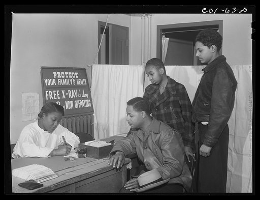 Miss Olive Smith interviewing applicants for x-rays at the x-ray clinic at the hospital of the Ida B. Wells Housing Project, Chicago, Illinois