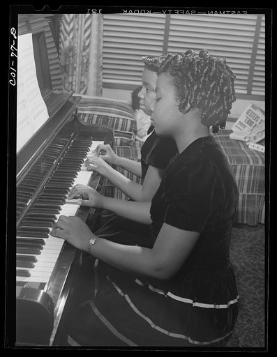 Untitled photo, possibly related to: Jelna and her sister Grace both play the piano. Jelna also plays the clarinet in the school band. Ida B. Wells Housing Project, Chicago, Illinois