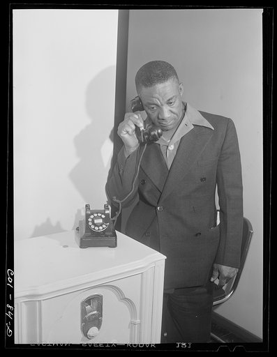 Mr. Roy Carr makes a phone call. He is in the junk business and owns his own truck. Ida B. Wells Housing Project, Chicago, Illinois