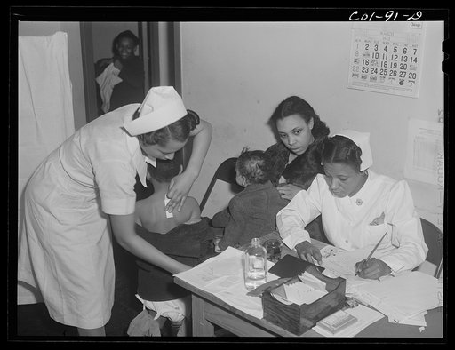 Mrs. Mary Flanagan brings her two children to the x-ray clinic at the Ida B. Wells Housing Project, Chicago, Illinois, to be x-rayed