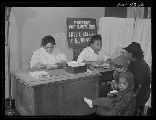 Mrs. Virginia McCoy brings her two children to the x-ray clinic at the hospital of the Ida B. Wells Housing Project, Chicago, Illinois, to be x-rayed