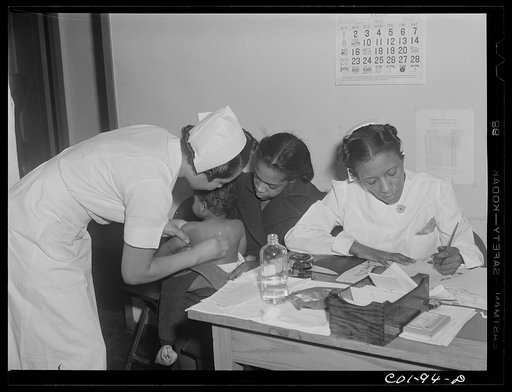 Untitled photo, possibly related to: Mrs. Mary Flanagan brings her two children to the x-ray clinic at the Ida B. Wells Housing Project, Chicago, Illinois, to be x-rayed