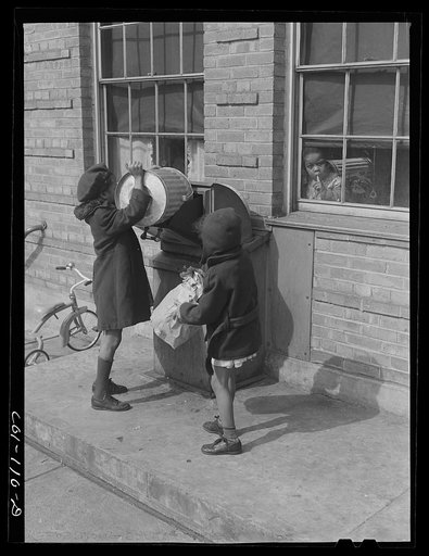 Children dumping garbage into one of the incinerators. Ida B. Wells Housing Project, Chicago, Illinois