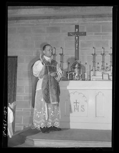 Father Smith, colored pastor, conducting Mass at a Negro Catholic church service on the South Side. Chicago, Illinois