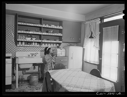 Rosemary Merchant washing dishes after dinner. Mr. and Mrs. Frank Merchant have a two-floor apartment--five rooms including kitchen and bath. Mr. Merchant works at the Carnegie Steel Company's South Chicago plant. They have three children: Frank, eight; Rosemary, eight; and baby, four months old. Id
