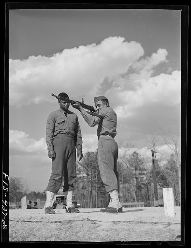 Fort Bragg, North Carolina. Sergeant Williams showing a soldier how to shoot
