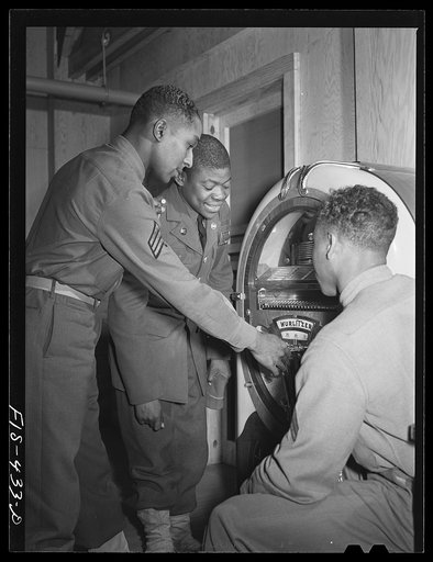 Fort Bragg, North Carolina. Sergeant Williams and friends playing a jukebox in the service club