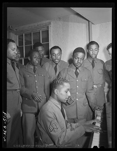 Untitled photo, possibly related to: Fort Bragg, North Carolina. Sergeant Williams and friends singing around the piano at the service club