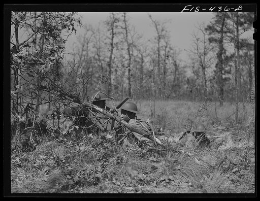 Untitled photo, possibly related to: Fort Bragg, North Carolina. Sergeant Williams leading a machine gun squad in a maneuver
