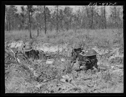 Untitled photo, possibly related to: Fort Bragg, North Carolina. Sergeant Williams leading a machine gun squad in a maneuver