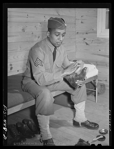 Fort Bragg, North Carolina. Sergeant Williams polishing his shoes in the barracks