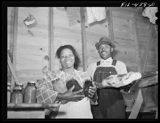 Untitled photo, possibly related to: Zebulon, North Carolina. Feggen Jones and wife in the smokehouse