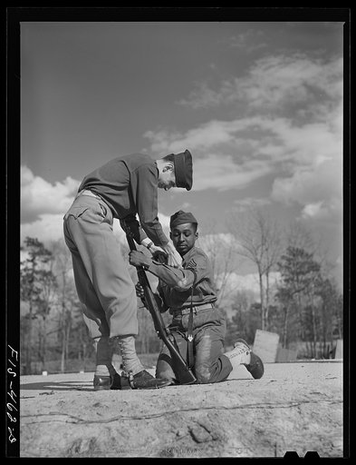 Fort Bragg, North Carolina. Officer showing Sergeant Williams how to shoot