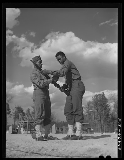 Untitled photo, possibly related to: Fort Bragg, North Carolina. Sergeant Williams showing a soldier how to shoot