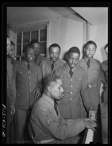 Fort Bragg, North Carolina. Sergeant Williams and friends singing around the piano at the service club