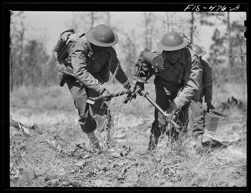 Untitled photo, possibly related to: Fort Bragg, North Carolina. Sergeant Williams leading a machine gun squad in a maneuver