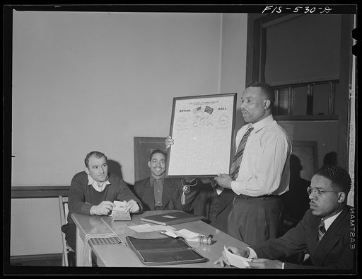 Chicago, Illinois. Good Shepherd Community Center. President of a steelworkers union local displaying honor roll on which names of members going into the armed forces will be listed