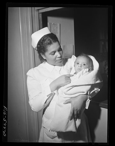 Chicago, Illinois. Provident Hospital. Miss Irene Hill, nurse technician, taking baby to be x-rayed