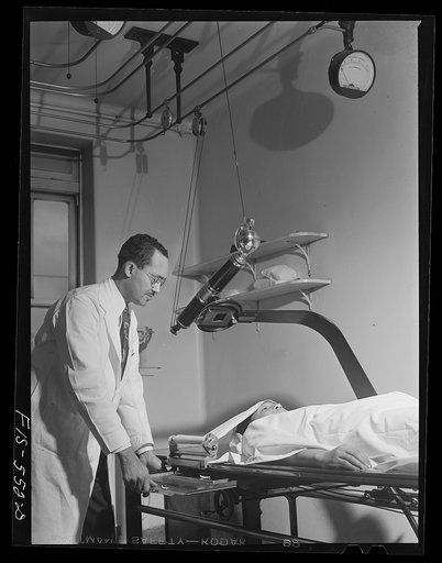Chicago, Illinois. Provident Hospital. Dr. B. W. Anthony adjusting an x-ray machine for taking a picture of a patient's skull