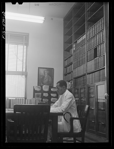 Chicago, Illinois. Provident Hospital. Dr. E.V. Williams, an intern, in the library