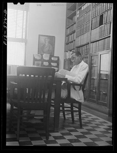 Untitled photo, possibly related to: Chicago, Illinois. Provident Hospital. Dr. E.V. Williams, an intern, in the library