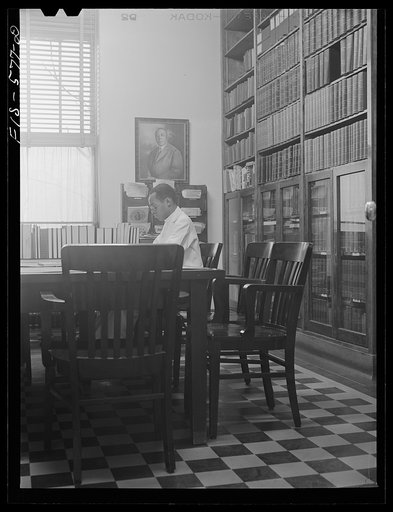 Untitled photo, possibly related to: Chicago, Illinois. Provident Hospital. Dr. E.V. Williams, an intern, in the library