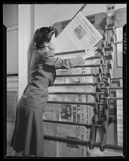 Untitled photo, possibly related to: Washington, D.C. Jewal Mazique [i.e. Jewel], worker at the Library of Congress, reading a hometown paper