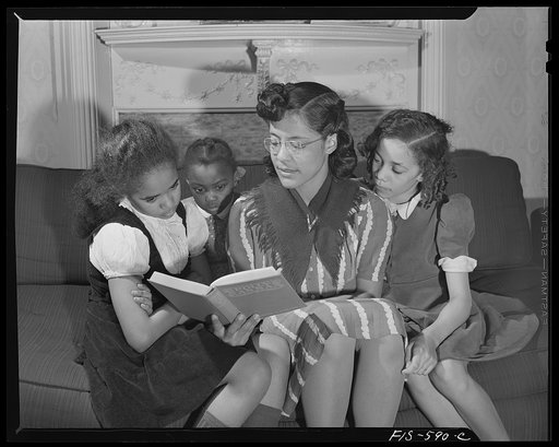 Washington, D.C. Jewal Mazique [i.e. Jewel], worker at the Library of Congress, reading to her little nieces whom she is raising and educating