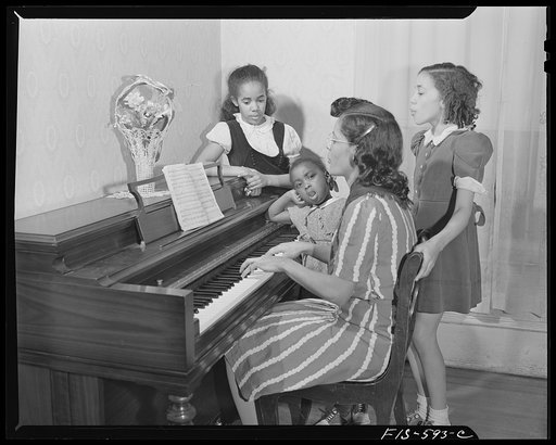 Untitled photo, possibly related to: Washington, D.C. Jewal Mazique [i.e. Jewel], worker at the Library of Congress, with her family, who all sing or play the piano