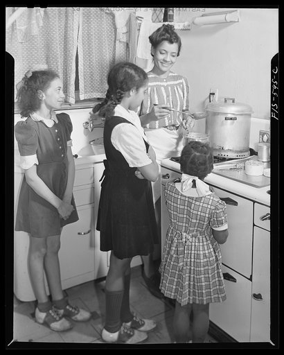 Washington, D.C. Jewal Mazique [i.e. Jewel], worker at the Library of Congress, cooking dinner for her husband and her three nieces whom she is raising and educating