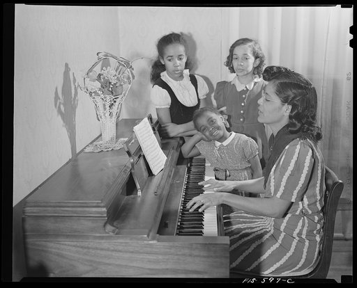 Washington, D.C. Jewal Mazique [i.e. Jewel], worker at the Library of Congress, with her family, who all sing or play the piano