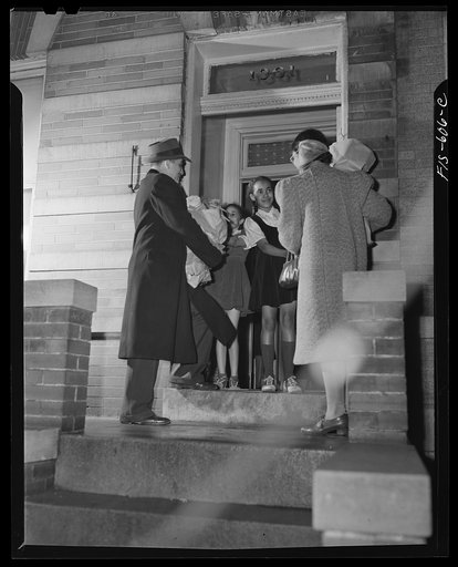 Untitled photo, possibly related to: Washington, D.C. Jewal Mazique [i.e. Jewel], worker at the Library of Congress, reading to her young nieces