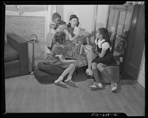 Untitled photo, possibly related to: Washington, D.C. Jewal Mazique [i.e. Jewel], worker at the Library of Congress, reading to her young nieces