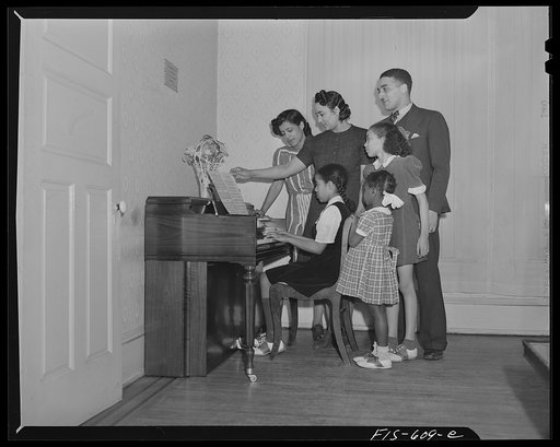 Untitled photo, possibly related to: Washington, D.C. All the family of Jewal Mazique [i.e. Jewel], worker at the Library of Congress, takes music lessons