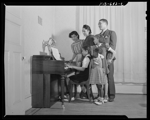 Untitled photo, possibly related to: Washington, D.C. All the family of Jewal Mazique [i.e. Jewel], worker at the Library of Congress, takes music lessons