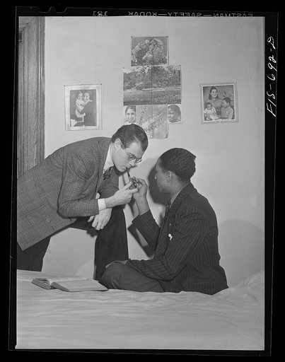 Untitled photo, possibly related to: Chicago, Illinois. Two of a group of young men who live cooperatively in a large house