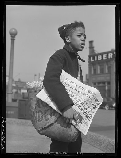 Untitled photo, possibly related to: Chicago, Illinois. Newsboy selling the Chicago Defender, a leading Negro newspaper