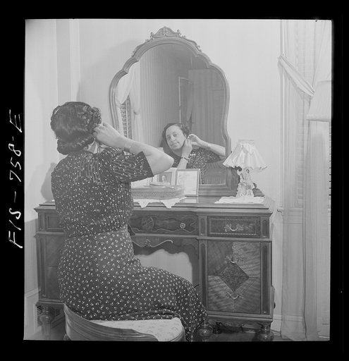 Washington, D.C. Teacher in a Negro grammar school in her bedroom at home. Her husband is a doctor