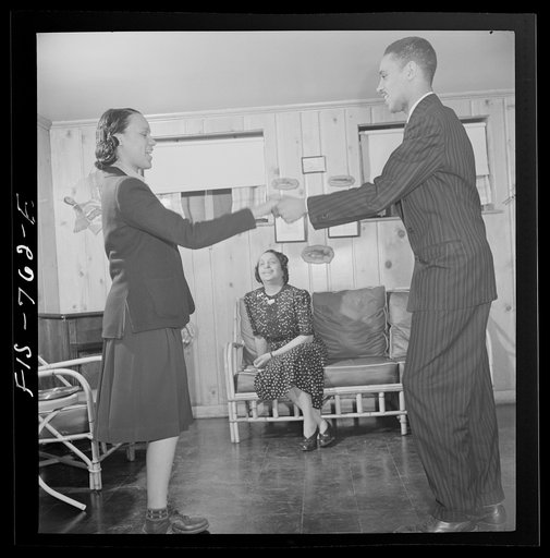Washington, D.C. Negro school teacher whose husband is a doctor watching her son and daughter hotstepping in the basement playroom of their home in the outskirts of Washington