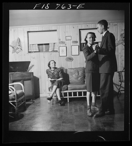 Untitled photo, possibly related to: Washington, D.C. Negro school teacher whose husband is a doctor watching her son and daughter hotstepping in the basement playroom of their home in the outskirts of Washington