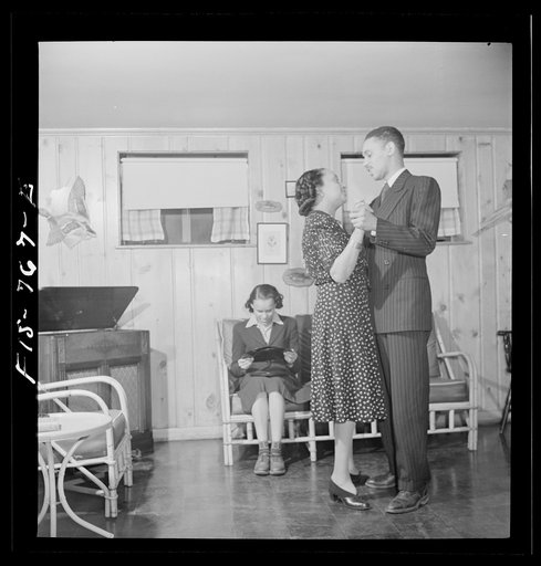 Untitled photo, possibly related to: Washington, D.C. Negro school teacher whose husband is a doctor watching her son and daughter hotstepping in the basement playroom of their home in the outskirts of Washington