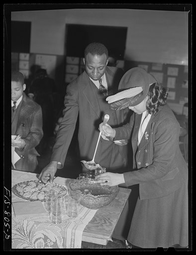 Chicago, Illinois. Ida B. Wells Housing Project. Serving punch at a meeting on a Sunday forum