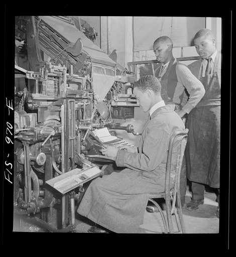 Washington, D.C. Setting type for the school paper on a lithograph machine at the Armstrong Technical High School