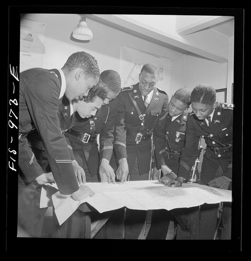 Untitled photo, possibly related to: Washington, D.C. Members of the military unit at the Armstrong Technical High School studying a map