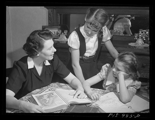 Minneapolis, Minnesota. Mrs. Brink helps Caren and Ruth with their lesson in the geography of Sweden