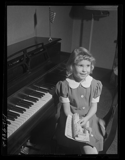 Minneapolis, Minnesota. Gloria Brink, seven, at the piano. She takes piano lessons