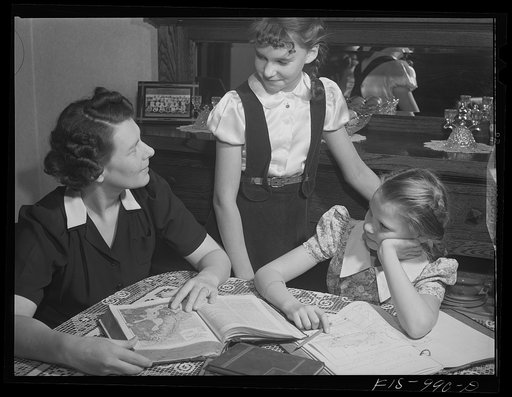 Untitled photo, possibly related to: Minneapolis, Minnesota. Mrs. Brink helps Caren and Ruth with their lesson in the geography of Sweden