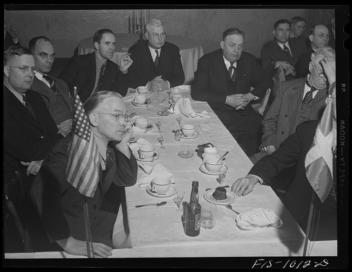 Untitled photo, possibly related to: Minneapolis, Minnesota. On the left, former state senator Swanson and on the right Mr. H.E. Brandt, listening to Mr. Peterson's speech