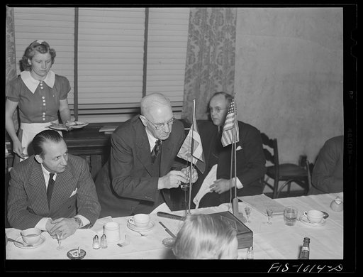 Minneapolis, Minnesota. Mr. Herman A. Larsen, president of the Swedish Club, raises the Swedish flag to signify the opening of the meeting. Mr. Peterson, the main speaker, is at the left. Mr. Larsen was born and educated in Stockholm. He learned photography in Sweden and on coming to the United Stat